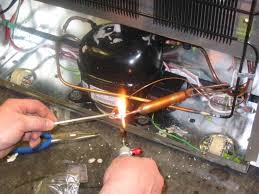 Welding copper pipes on a refrigeration unit
